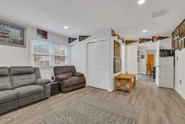 a view of a livingroom with furniture and workspace