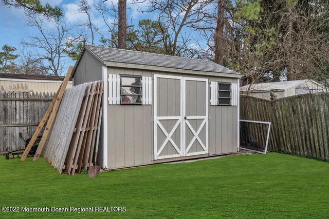 a view of a yard with a fence and trees