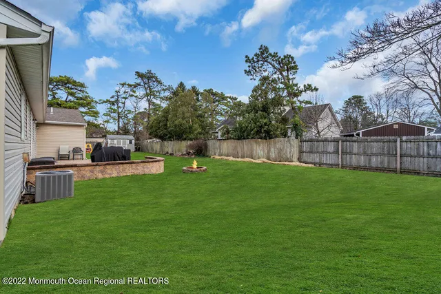 a backyard of a house with table and chairs