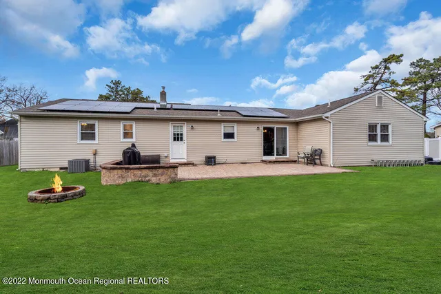 a backyard of a house with table and chairs