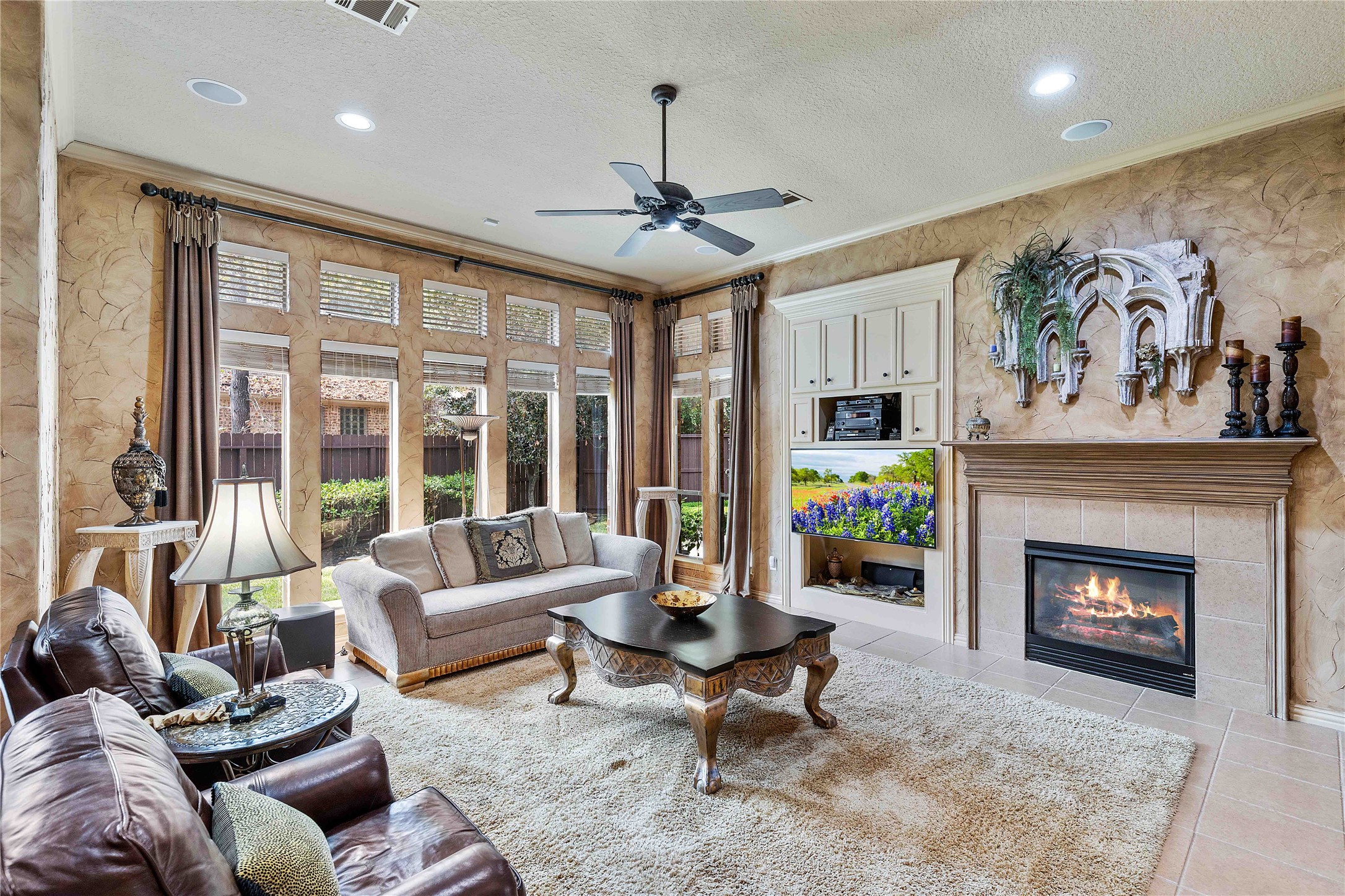 7 North Spring Brook Court Spring, TX 77382 - Photo 13 of 49 The large living room with a cozy fireplace has room for friends, family, and guests to sit and enjoy together.