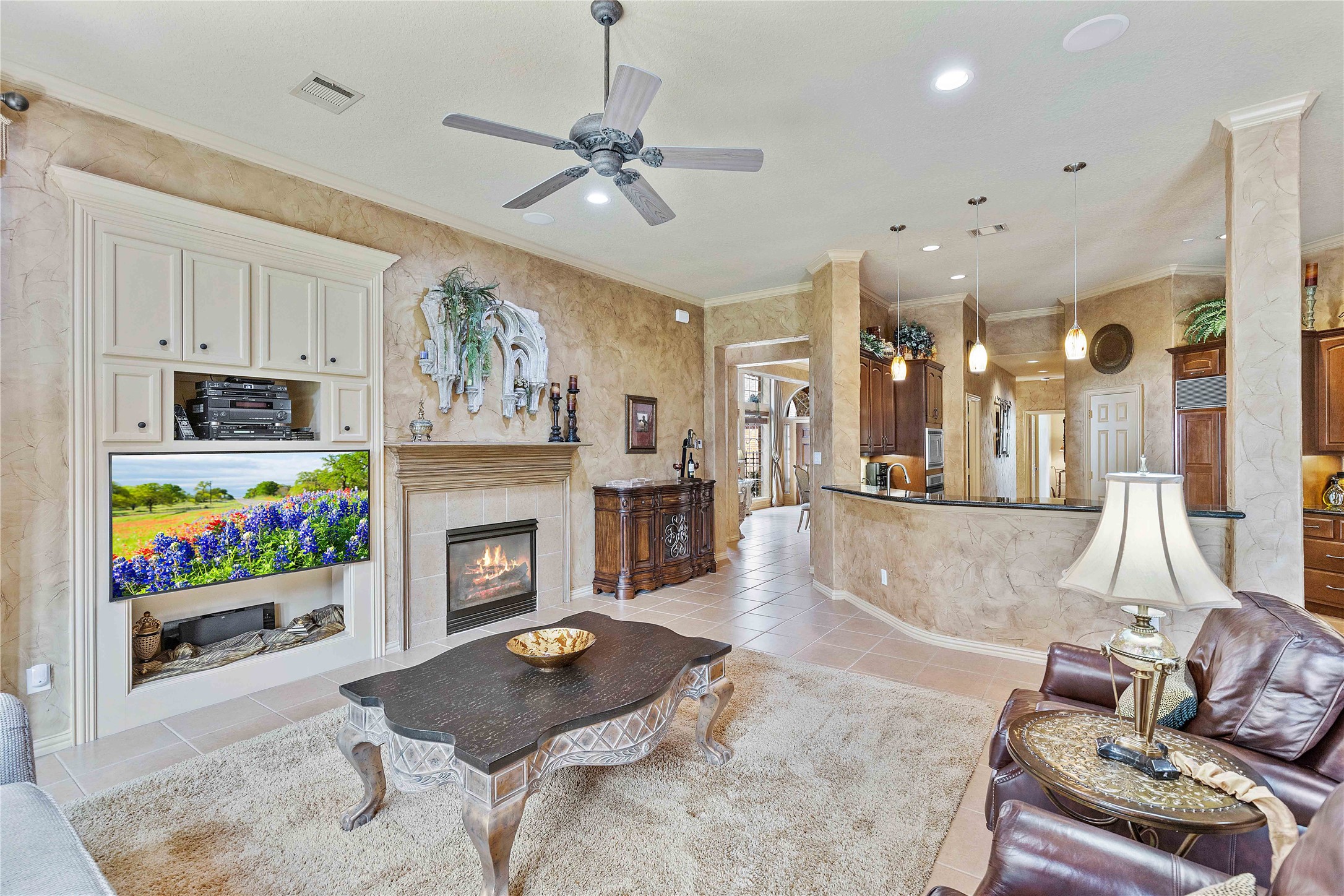 7 North Spring Brook Court Spring, TX 77382 - Photo 14 of 49 The kitchen is right next to the living room, perfect for keeping conversation flowing while still utilizing the kitchen and the large bar area.