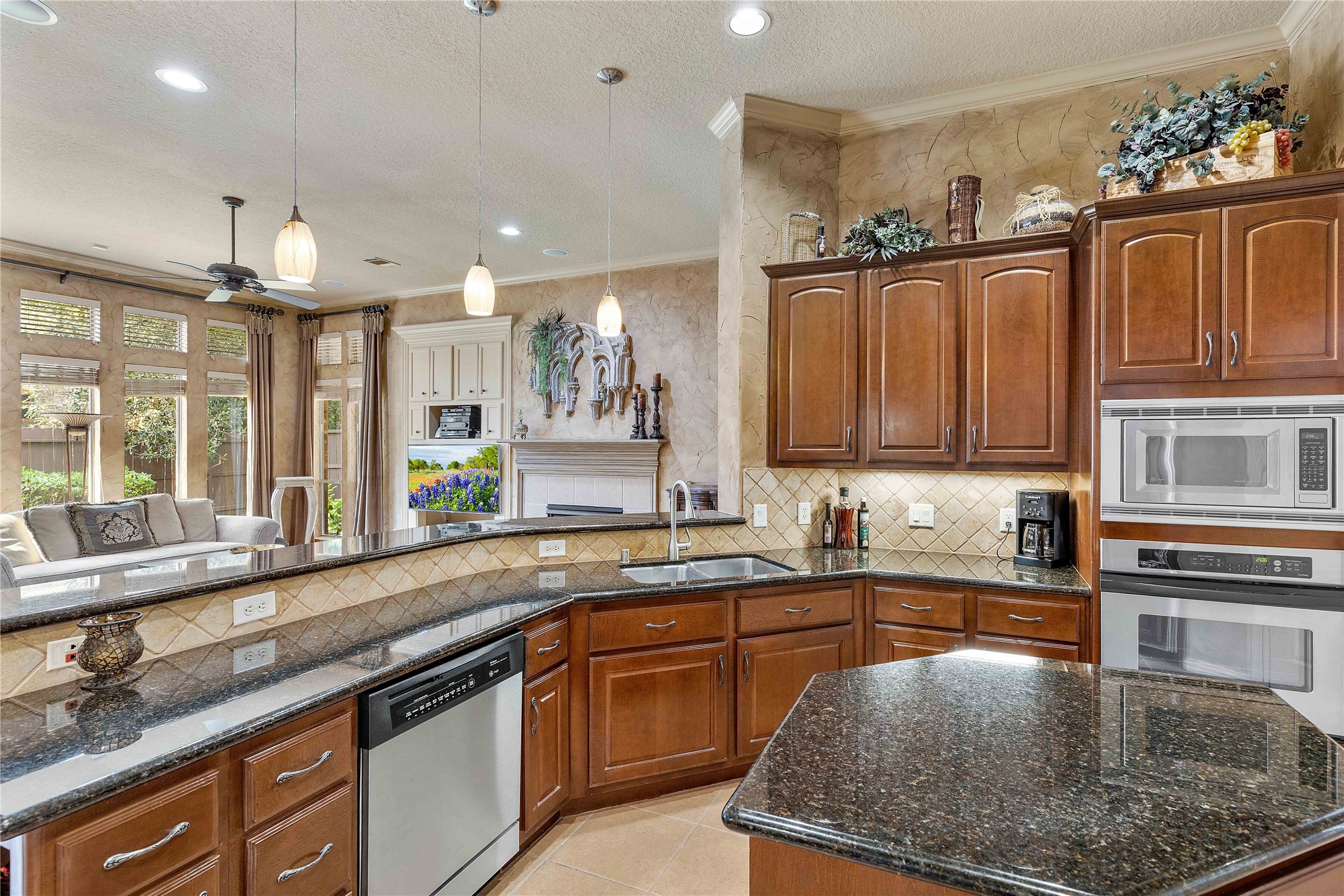 7 North Spring Brook Court Spring, TX 77382 - Photo 22 of 49 Your view from the sink will extend into the living room, keeping conversation and TV entertainment alive.