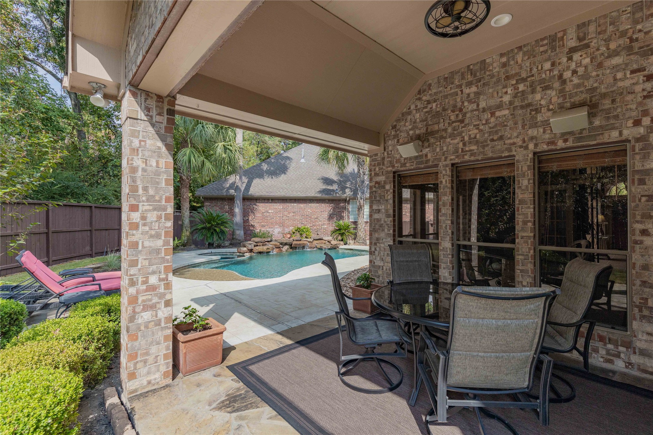 7 North Spring Brook Court Spring, TX 77382 - Photo 38 of 49 The second area of the patio is perfect for sitting outside to enjoy a meal and a ballgame on the TV!