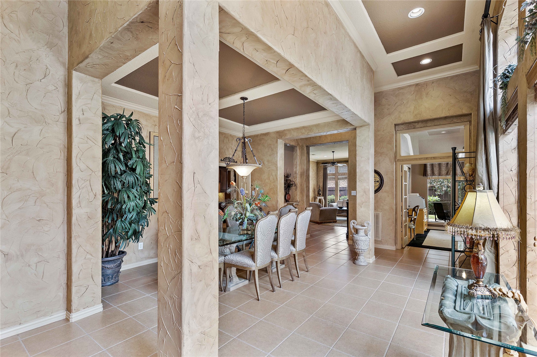 7 North Spring Brook Court Spring, TX 77382 - Photo 6 of 49 This elegant home features a spacious open layout with high ceilings and stylish columns. The dining area is complemented by large windows, allowing natural light to enhance the sophisticated decor. Perfect for entertaining and comfortable living.