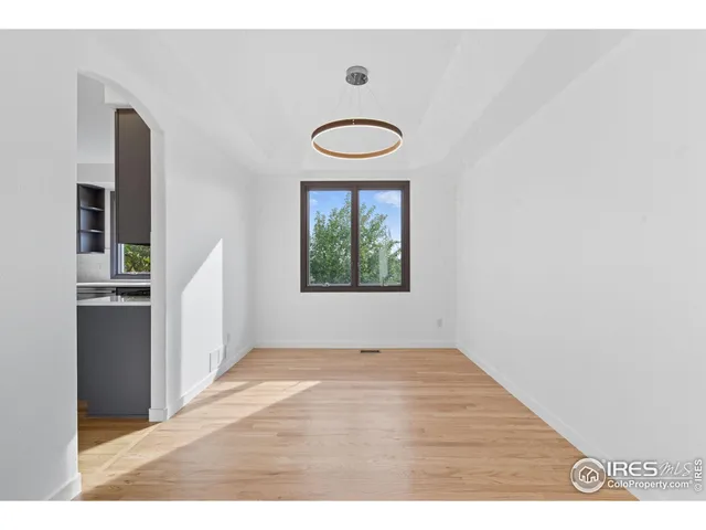 a view of a room with wooden floor and window