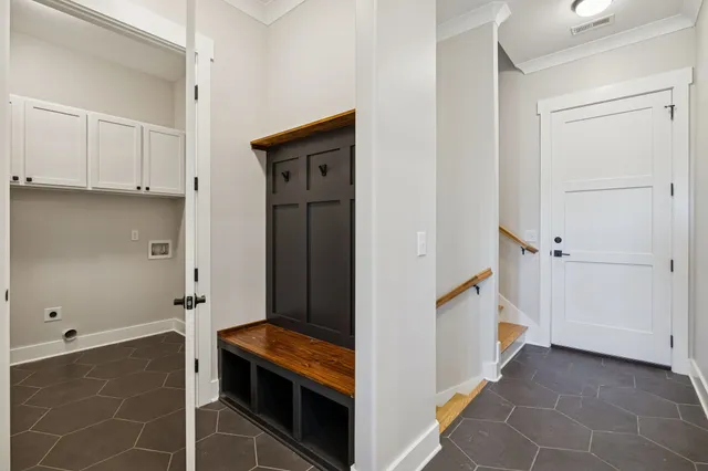 a view of a hallway with closet and a bathroom