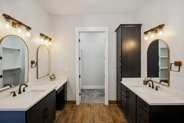 a bathroom with a granite countertop sink a mirror and a shower