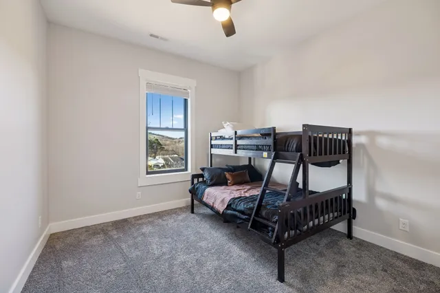 a bedroom with a bed and a view of en suite bathroom
