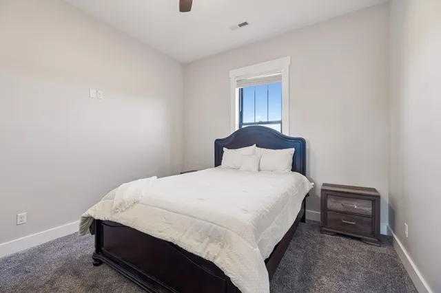 a bedroom with a bed and a dresser