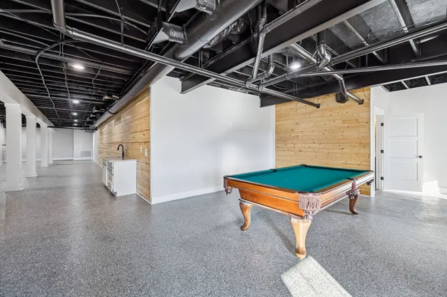 a kitchen with a sink a table and chairs