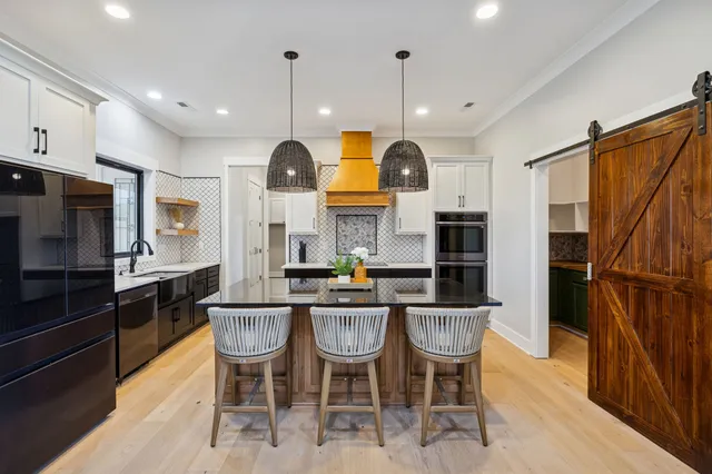 a kitchen with sink stove and living room
