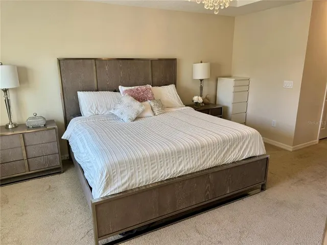 a bedroom with a bed and a night stand