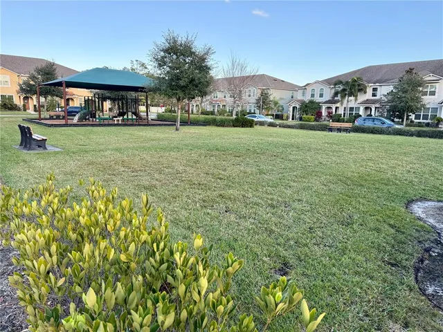 a view of a house with backyard porch and sitting area