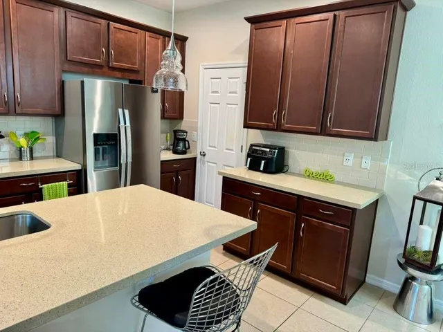 a kitchen with stainless steel appliances a refrigerator sink and cabinets