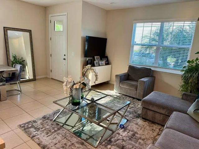 a living room with furniture and a flat screen tv