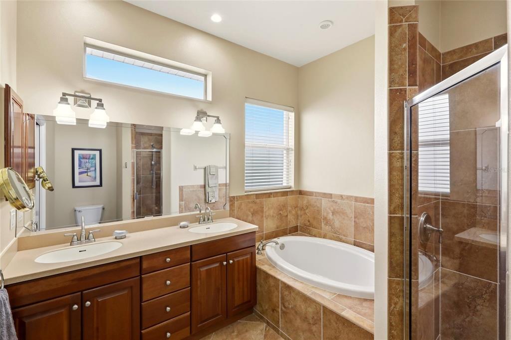 508 Fallbrook Drive Venice, FL 34292 - Photo 14 of 20 a bathroom with a tub double vanity sink and mirror