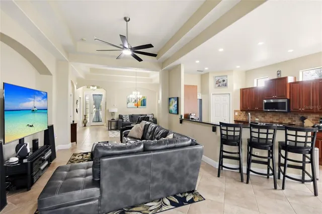 a living room with furniture a dining table and a fireplace