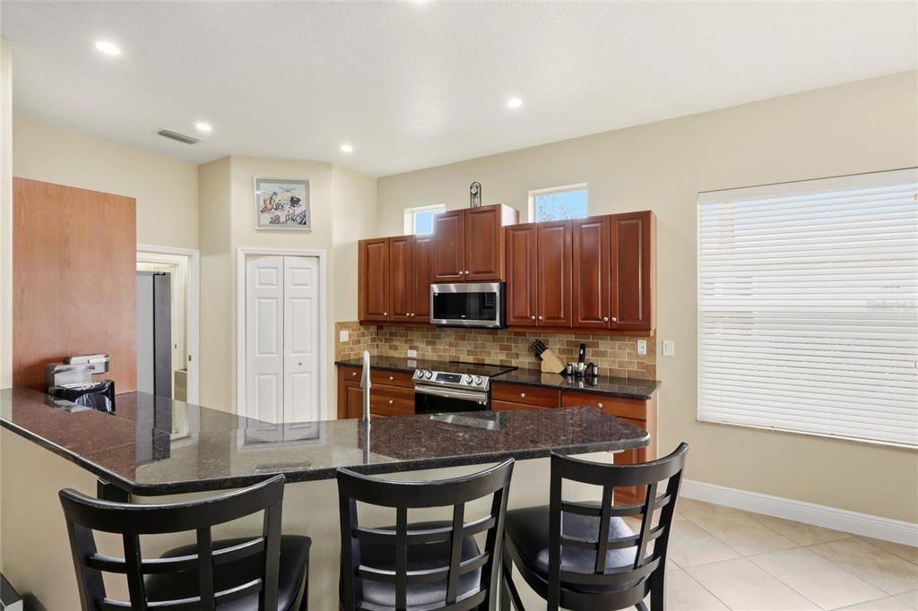 508 Fallbrook Drive Venice, FL 34292 - Photo 7 of 20 a kitchen with a dining table chairs and a refrigerator