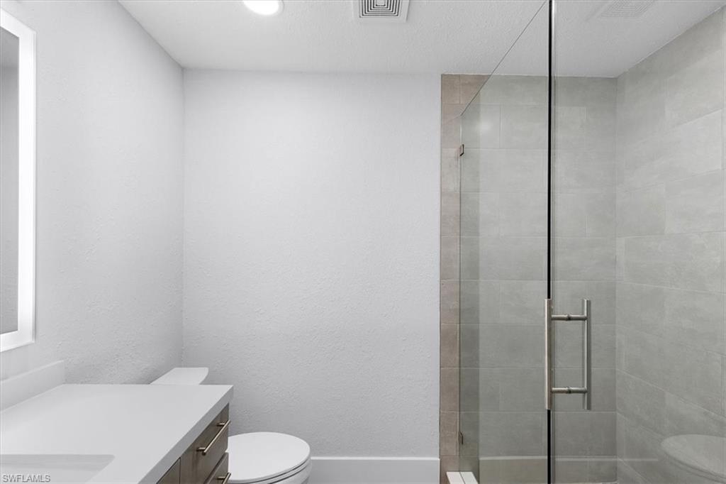 3240 Collee Court Naples, FL 34112 - Photo 24 of 42 a bathroom with a toilet and a shower