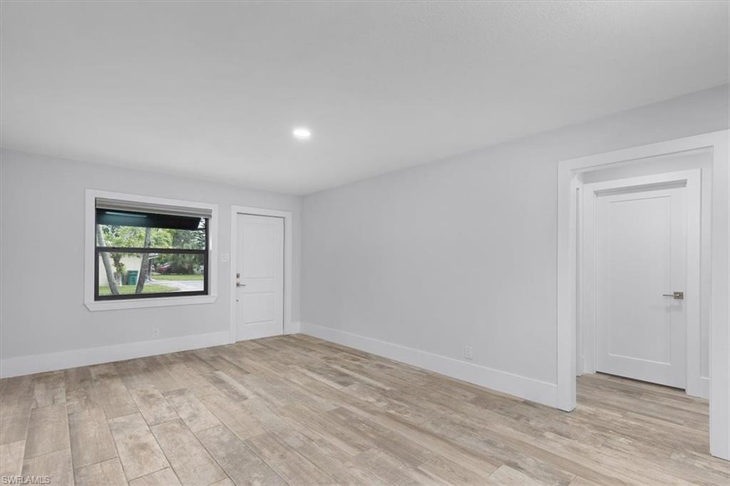 3240 Collee Court Naples, FL 34112 - Photo 8 of 42 a view of empty room with wooden floor and fan