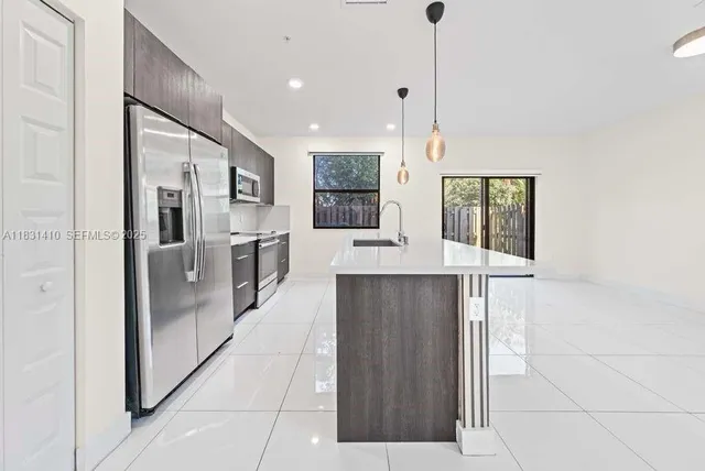 a view of a kitchen with a sink and a living room