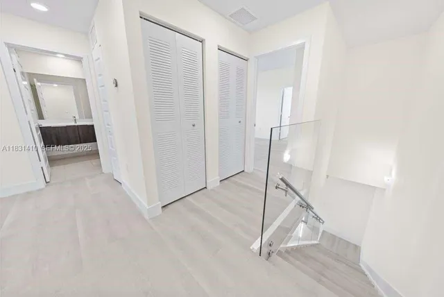 a view of a hallway with wooden floor