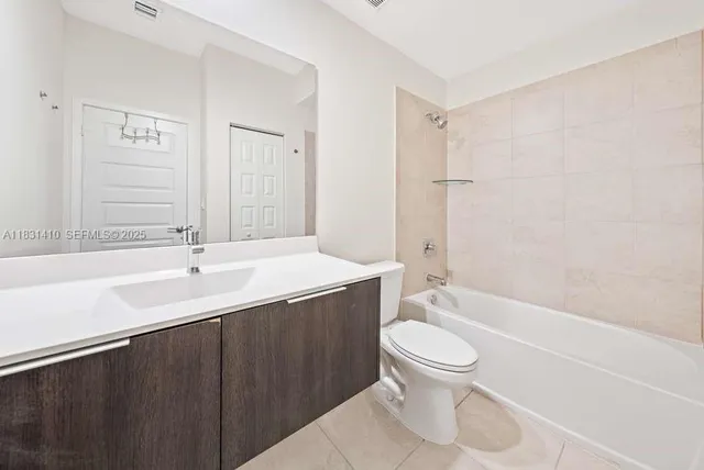 a bathroom with a toilet sink and shower