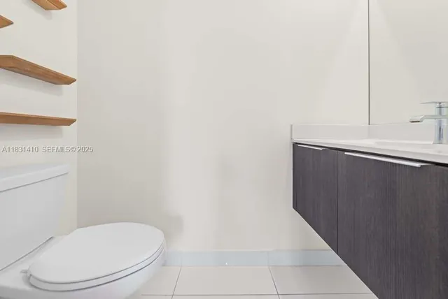 an empty room with a painting on the wall