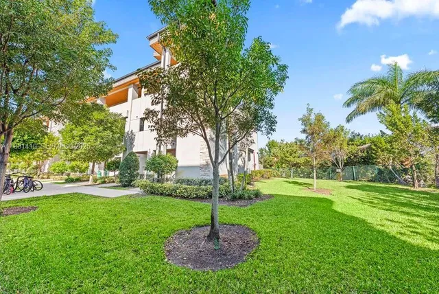 a large kitchen with stainless steel appliances kitchen island granite countertop a refrigerator a stove a sink and a microwave