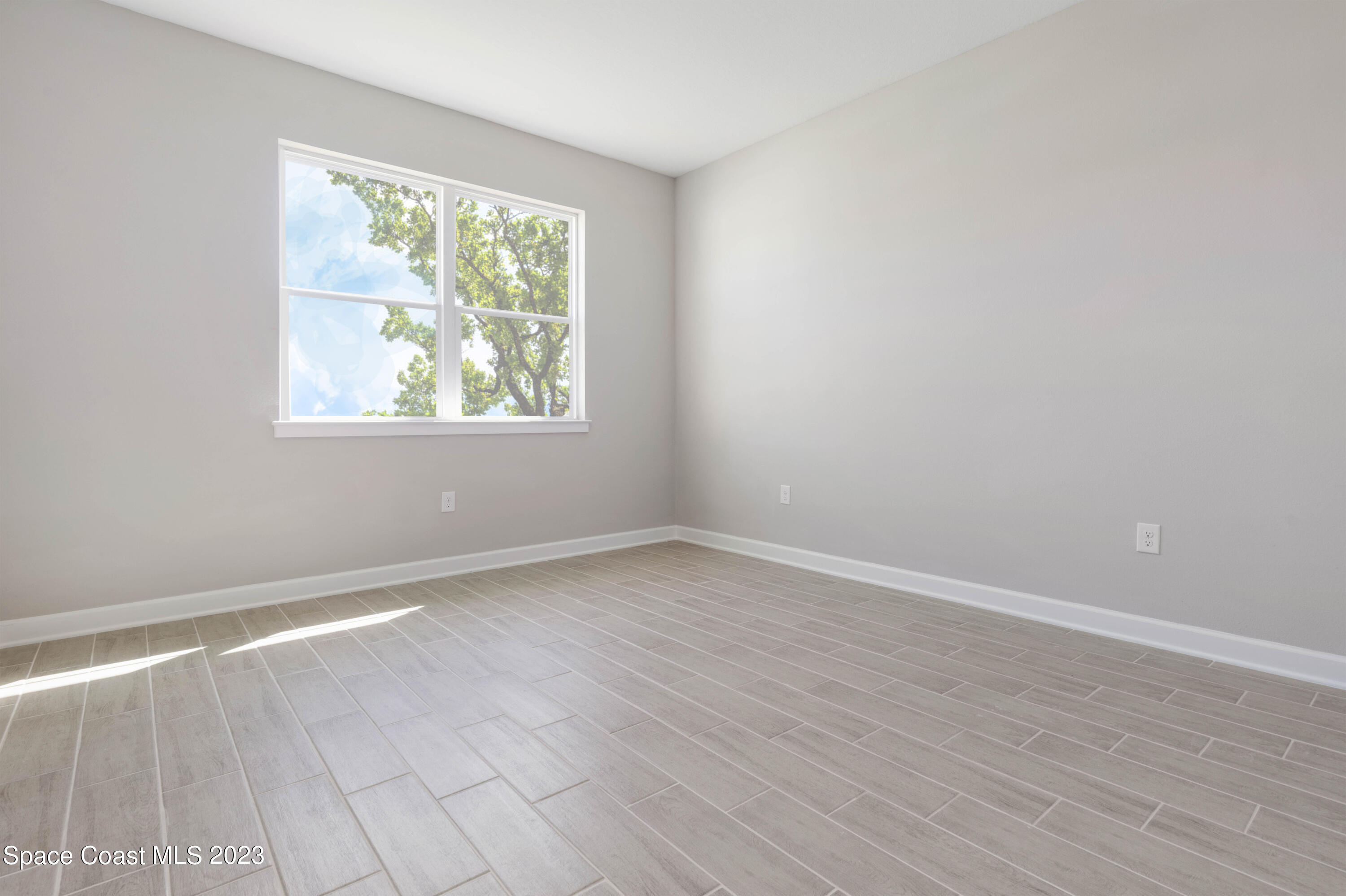 407 Hallcrest Street Palm Bay, FL 32908 - Photo 15 of 25 an empty room with wooden floor and windows