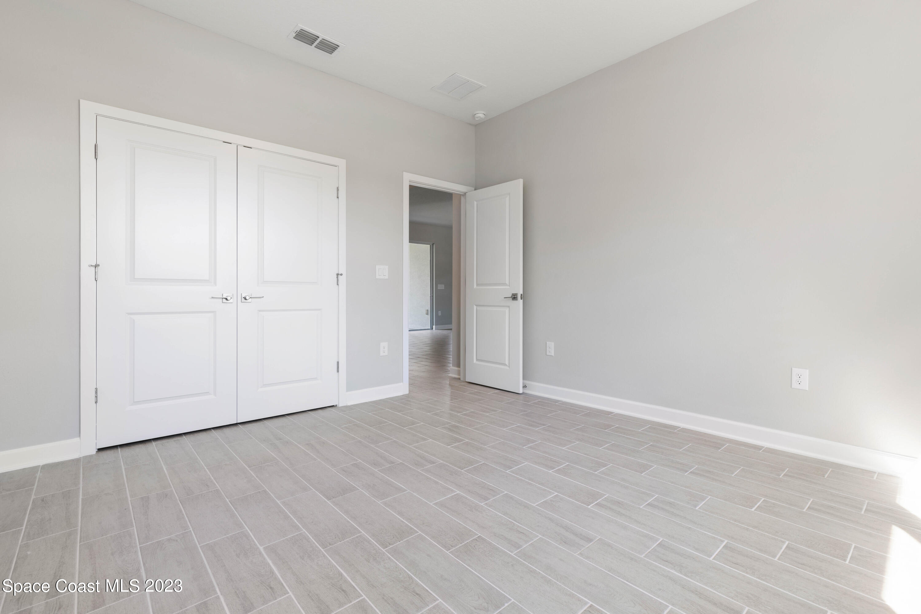 407 Hallcrest Street Palm Bay, FL 32908 - Photo 16 of 25 a view of an empty room and wooden floor
