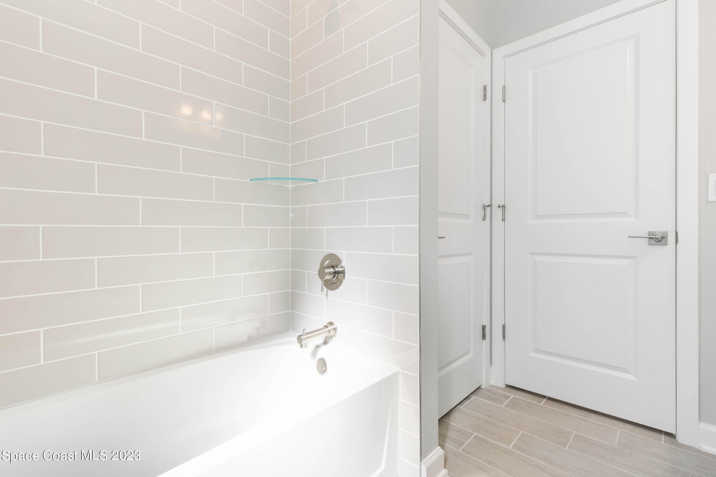407 Hallcrest Street Palm Bay, FL 32908 - Photo 23 of 25 a bathroom with a bathtub