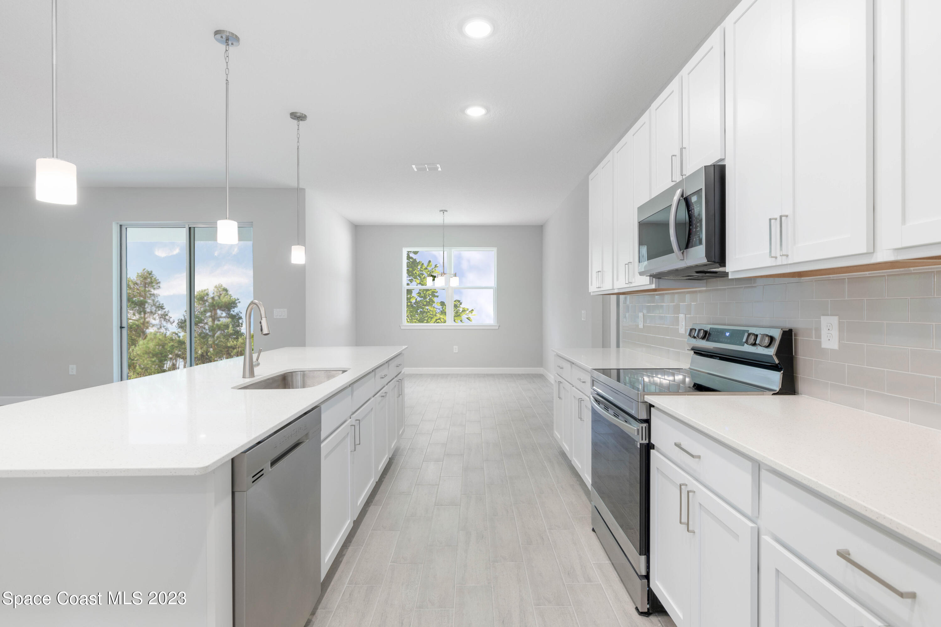 407 Hallcrest Street Palm Bay, FL 32908 - Photo 10 of 25 a kitchen with a sink stove and microwave