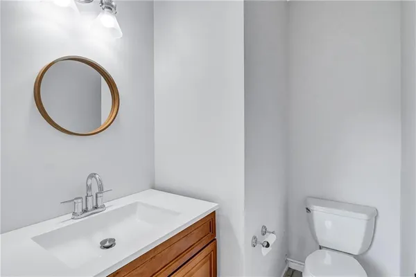 a bathroom with a toilet sink and mirror