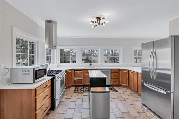 a kitchen with stainless steel appliances granite countertop a sink stove and refrigerator