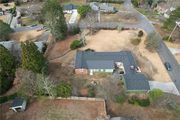 an aerial view of a house with a yard