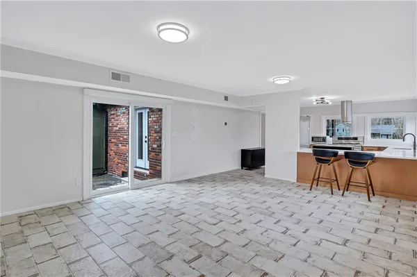 a view of a livingroom with furniture and a kitchen