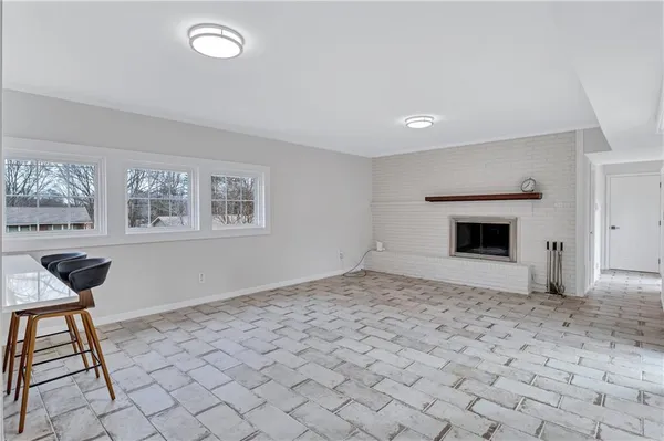 a view of empty room with a fireplace