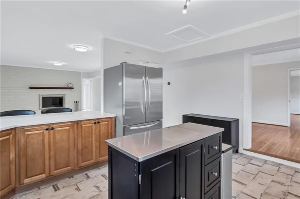 a kitchen with stainless steel appliances a sink and a refrigerator