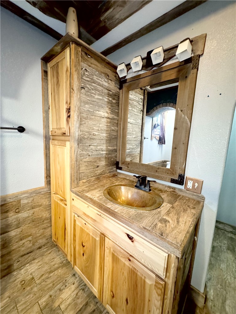 403 Staples Street Alice, TX 78332 - Photo 8 of 15 a bathroom with a granite countertop sink and a mirror