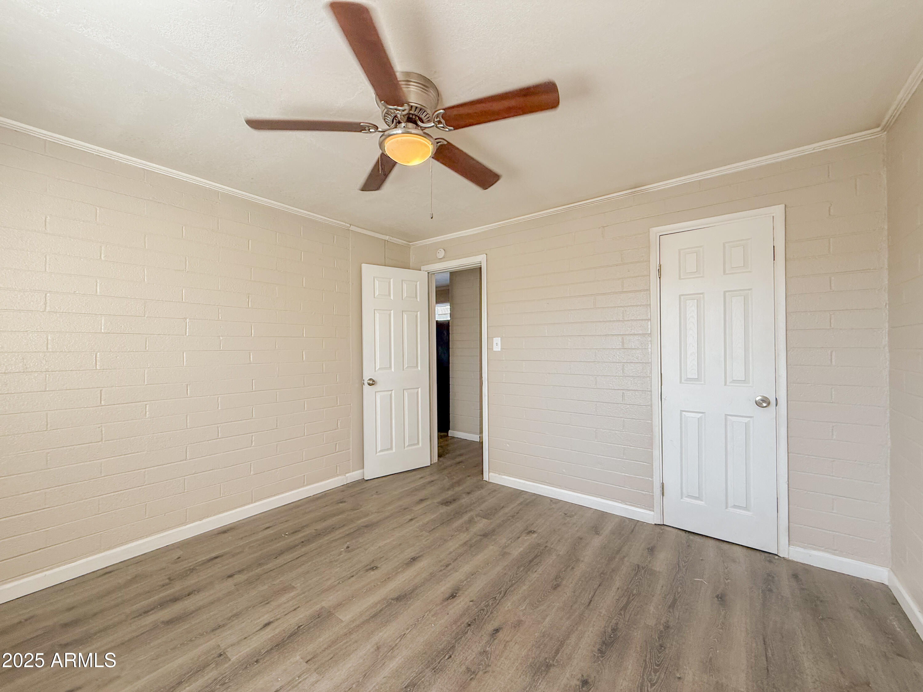 2 East Navajo Road, Unit E Tucson, AZ 85705 - Photo 11 of 15 a view of an empty room with wooden floor