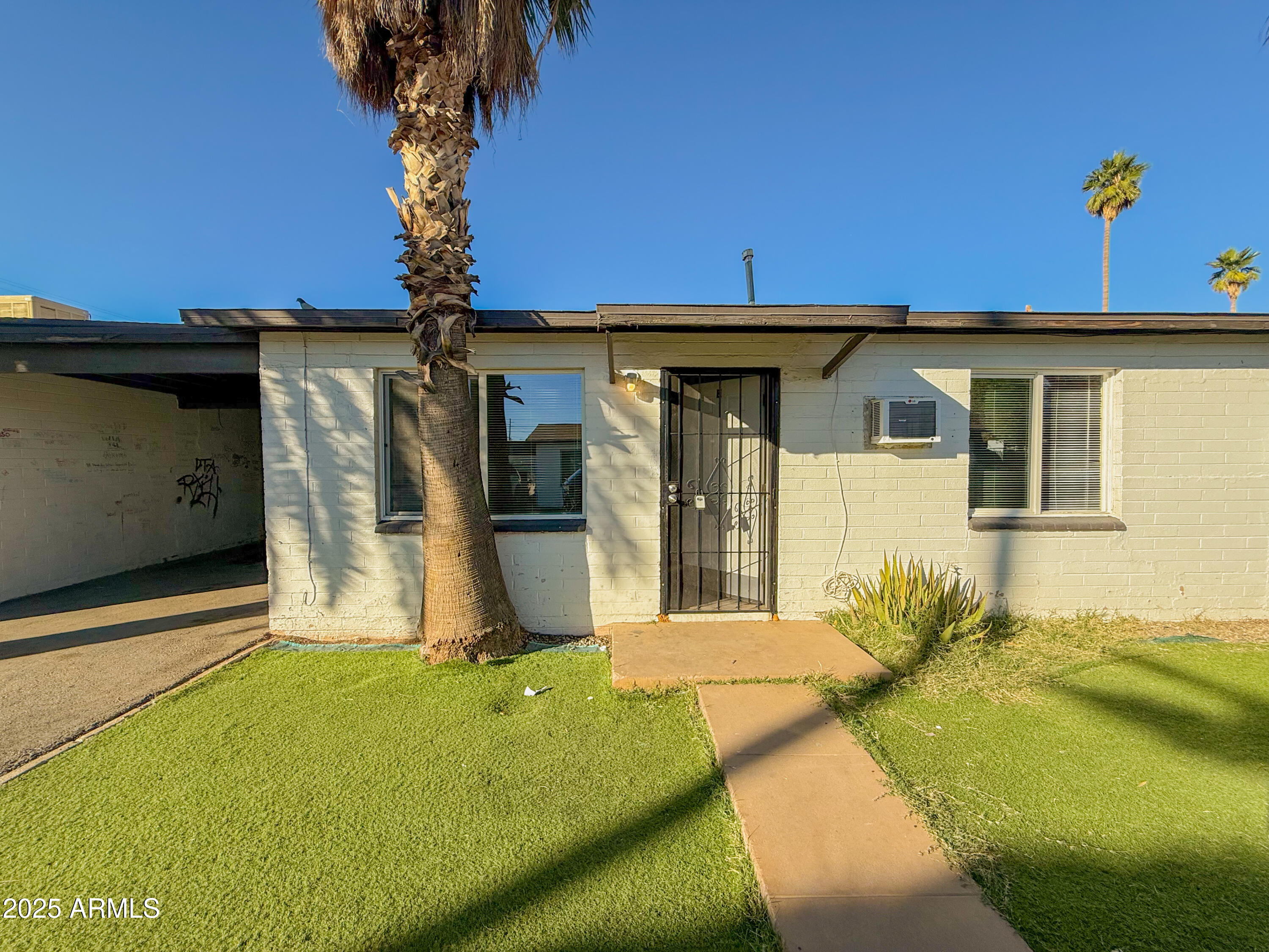 2 East Navajo Road, Unit E Tucson, AZ 85705 - Photo 2 of 15 a front view of a house with basket ball court and outdoor seating