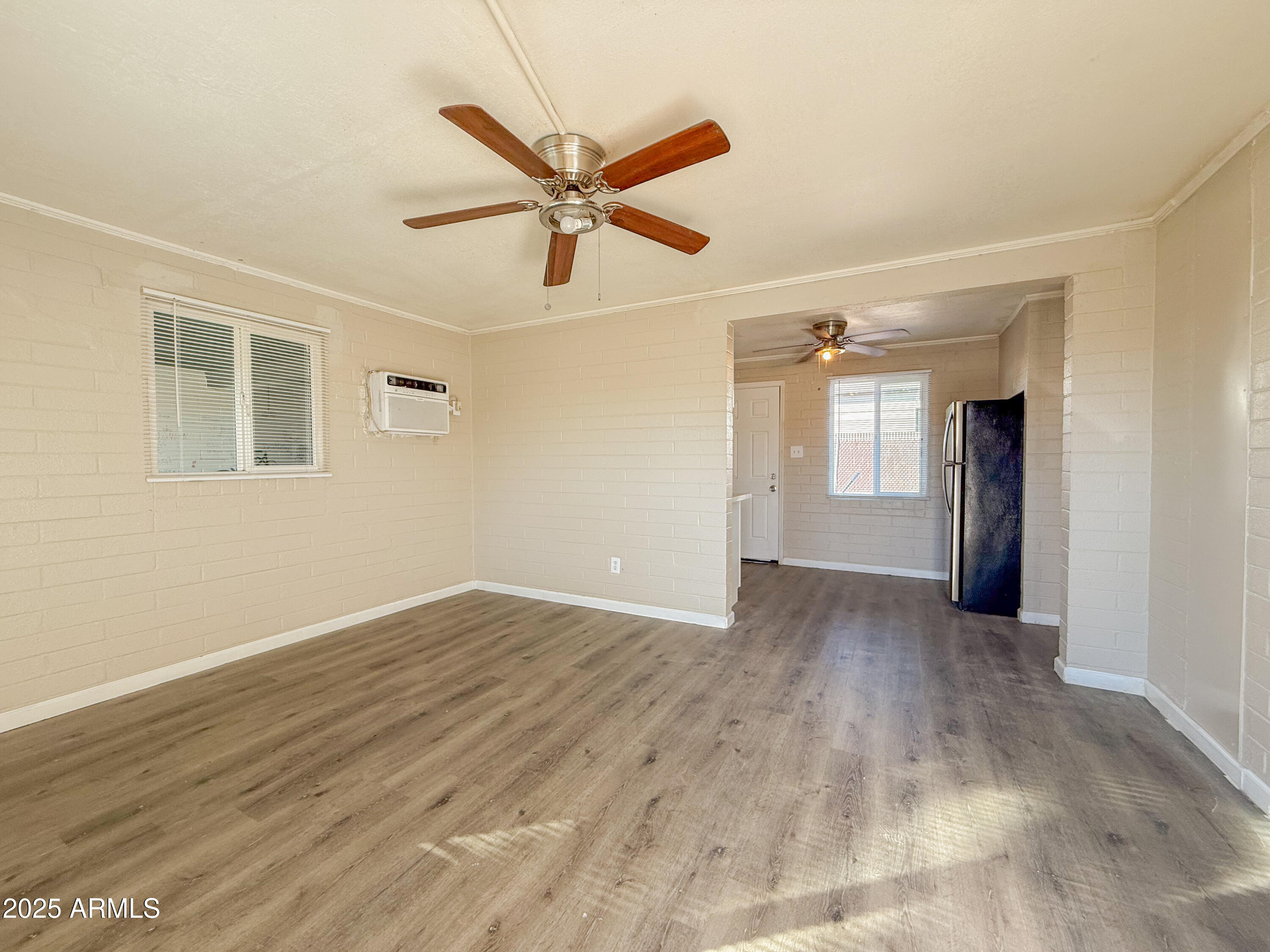 2 East Navajo Road, Unit E Tucson, AZ 85705 - Photo 4 of 15 wooden floor in an empty room with a window