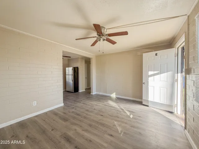 a view of a livingroom with a ceiling fan and window