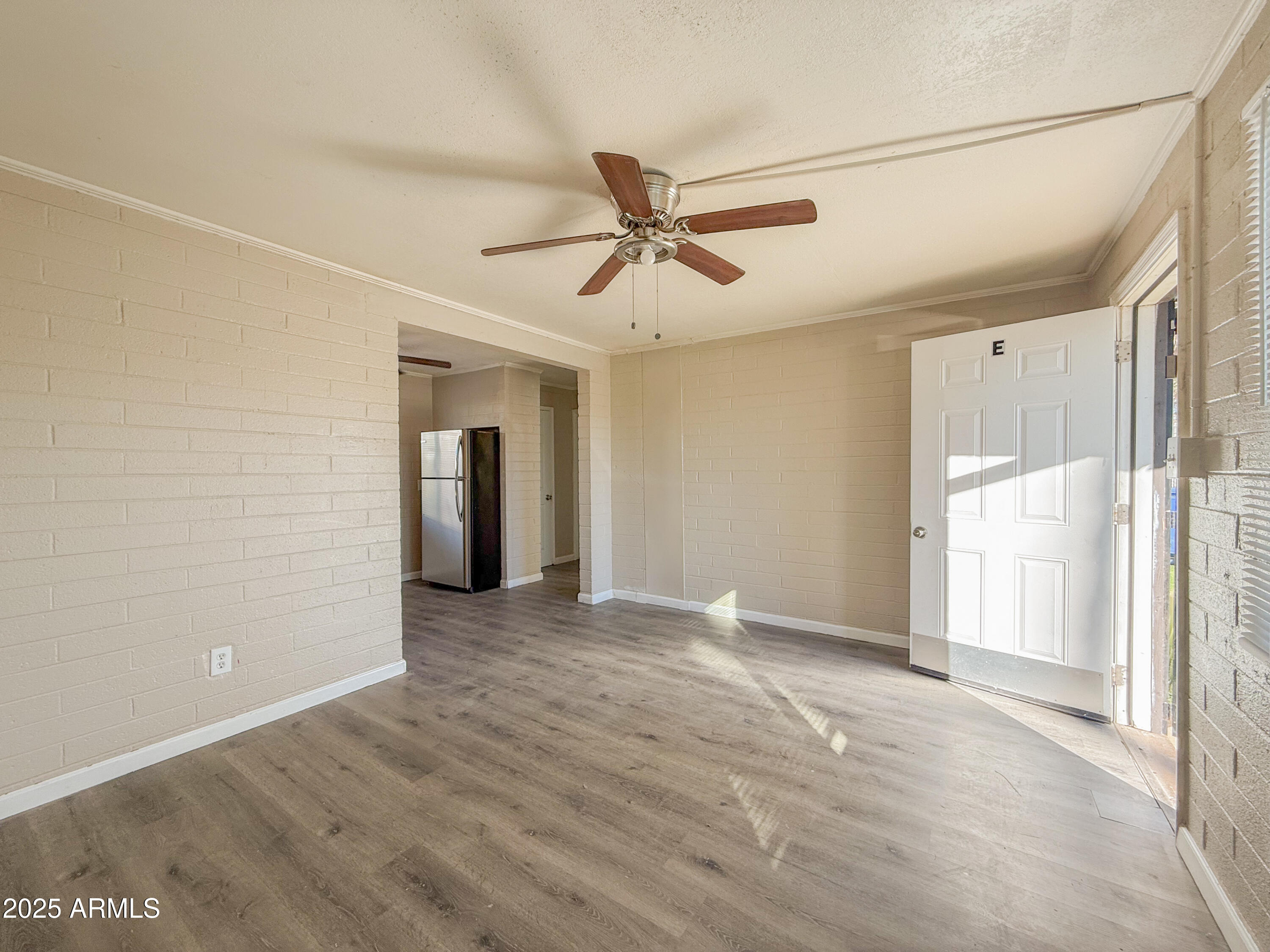 2 East Navajo Road, Unit E Tucson, AZ 85705 - Photo 5 of 15 a view of a livingroom with a ceiling fan and window