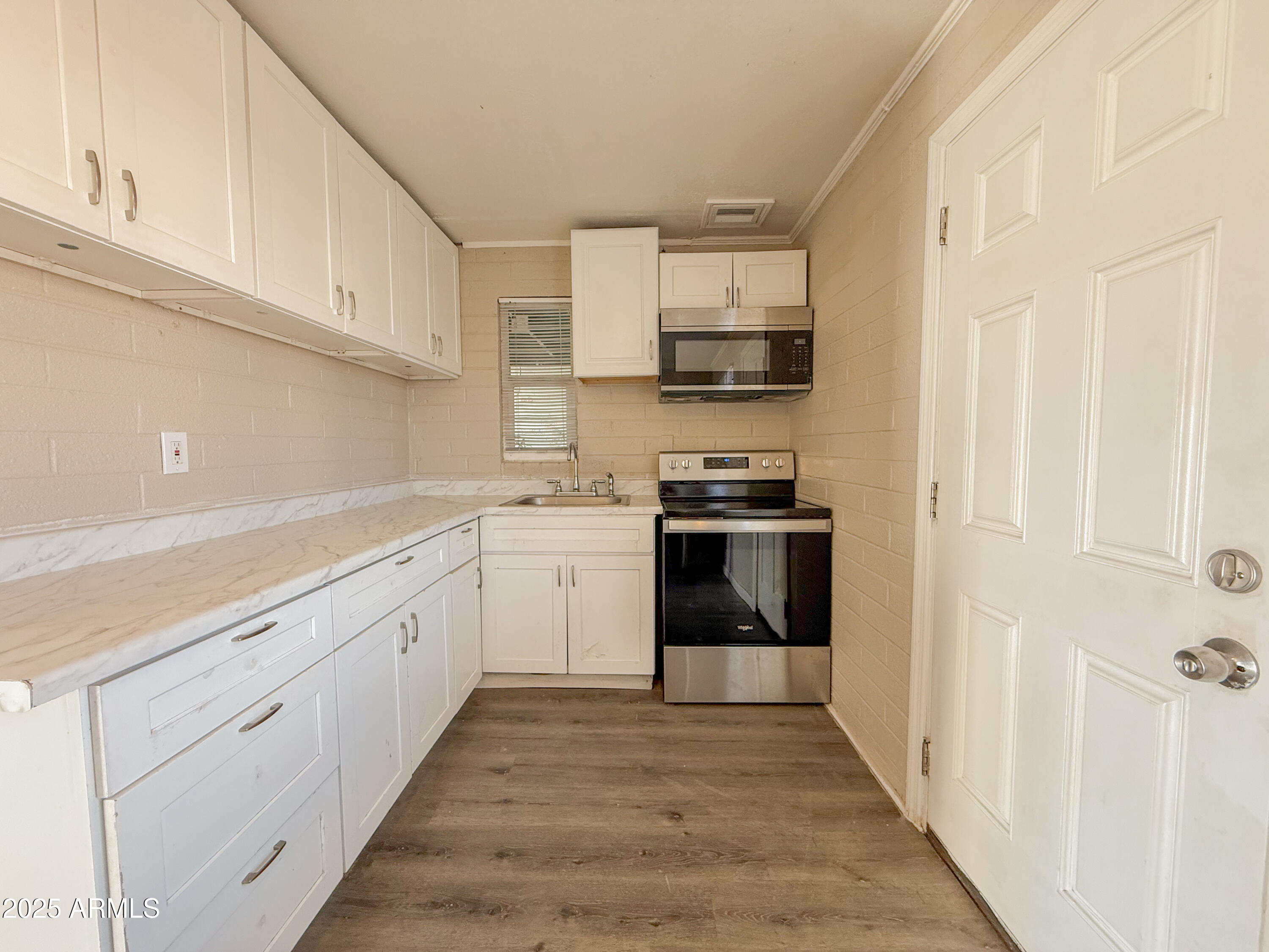 2 East Navajo Road, Unit E Tucson, AZ 85705 - Photo 6 of 15 a kitchen with stainless steel appliances granite countertop a refrigerator and a sink