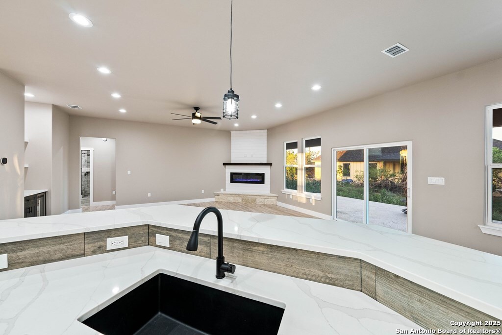 502 Sumack Kerrville, TX 78028 - Photo 11 of 58 a view of a kitchen with a sink stainless steel appliances and cabinets