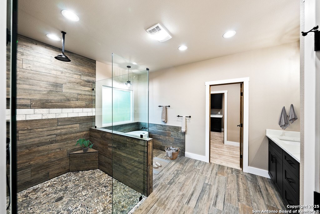 502 Sumack Kerrville, TX 78028 - Photo 19 of 58 a kitchen with stainless steel appliances kitchen island granite countertop a refrigerator a sink and wooden floors