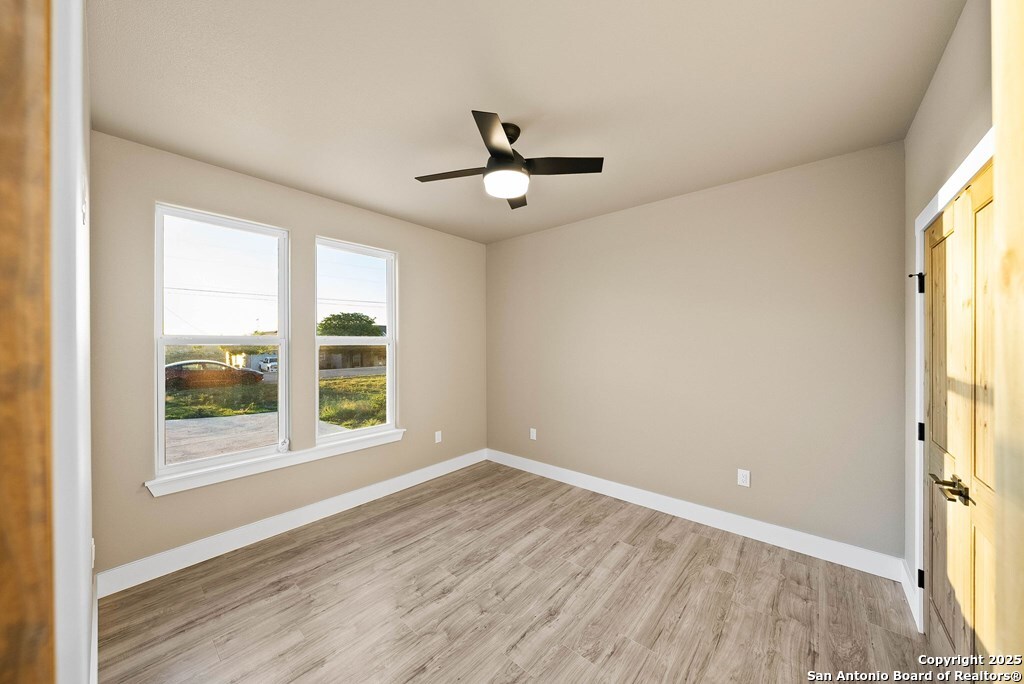 502 Sumack Kerrville, TX 78028 - Photo 29 of 58 wooden floor in an empty room with a window